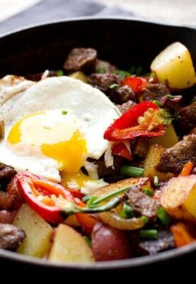 Carne Asada Hash: You'll dream of this hearty, but fast, breakfast after you try it. The perfect mix of tender steak, crispy potatoes, and spicy peppers. Plus, a perfect egg of course. Happy weekend. | macheesmo.com
