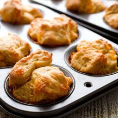 Pull Apart Cheddar Buttermilk Biscuits: Made from scratch biscuits with loads of sharp cheddar folded in. Chopped up (monkey bread style) and baked in muffin tins so they pull apart easily. Great for kiddos or adults! | macheesmo.com