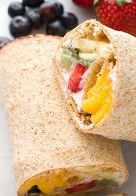 Rainbow Breakfast Wraps: These quick wraps are so quick to make an a perfect way to start the day. Packed with granola, Greek yogurt, and colorful fruits and stuffed inside a flatbread. #sponsored | macheesmo.com