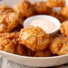 Bited Sized Blooming Onions: The perfect bite-sized version of the popular fried onion appetizer! Easy to share and easy to eat! So delicious and crispy with a soft slightly sweet and tangy bite. So good!