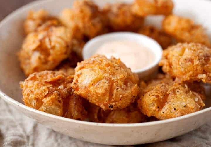 Bited Sized Blooming Onions: The perfect bite-sized version of the popular fried onion appetizer! Easy to share and easy to eat! So delicious and crispy with a soft slightly sweet and tangy bite. So good!