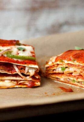 Pepperoni Pizza Stack: The key to this beautiful and delicious creature is to use thin crusts so the finished stack isn't too dough-filled! Layers of cheese, pepperoni, peppers, and onions makes for one delicious stack. I like to use Flatout Flatbread Artisan Thin Crust Pizza Crusts for my layers! #sponsored | macheesmo.com