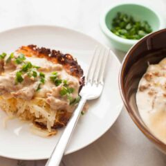 Potato Casserole with Sausage Gravy: This is slow comfort food at its best. Homemade simple potato casserole with fresh potatoes topped with a hearty sausage gravy. Comfort food on a plate! | macheesmo.com