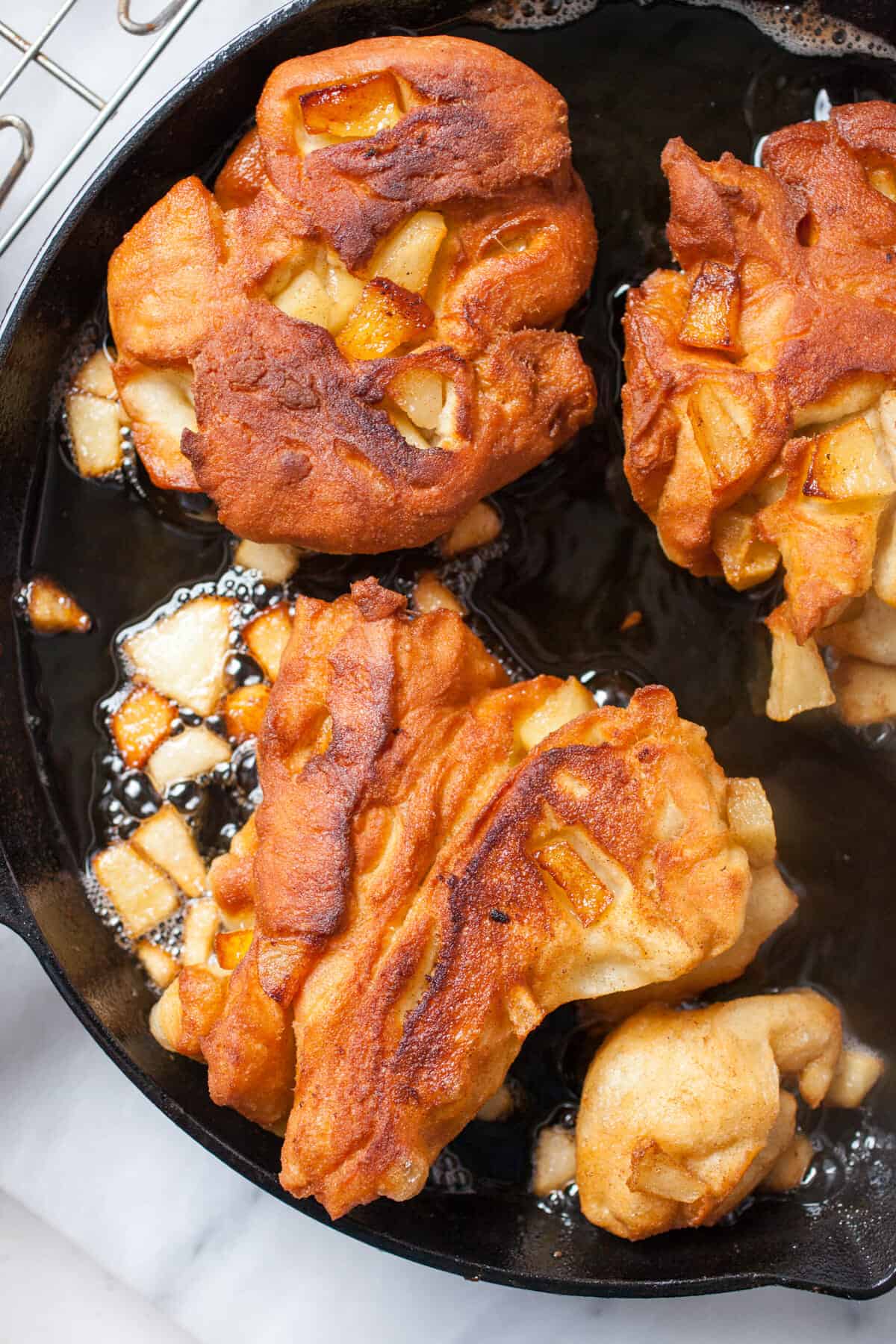 Cast Iron Homemade Apple Fritters: Soft homemade donut dough folded with apples and spices and fried in a cast iron skillet for a crispy exterior crust. Comfort food at its best. | macheesmo.com