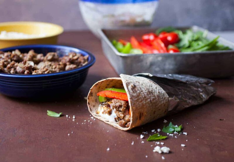 Lamb Gyro Flatbread Wraps: Savory ground lamb served with a labneh tzatziki sauce and fresh veggies in a Flatbread wrap. One of my new favorite wraps, for sure! | Macheesmo.com