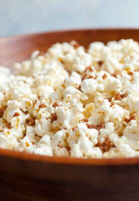 Bacon Dust Popcorn: A bacon lover's dream. This popcorn is coated with big spoonfuls of what I call bacon dust. Dried and ground bacon bits with salt and sugar mixed in. It's a perfect snack topper. Enjoy! | macheesmo.com