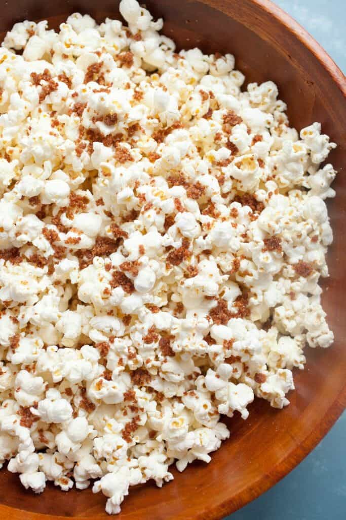 Bacon Dust Popcorn: A bacon lover's dream. This popcorn is coated with big spoonfuls of what I call bacon dust. Dried and ground bacon bits with salt and sugar mixed in. It's a perfect snack topper. Enjoy! | macheesmo.com