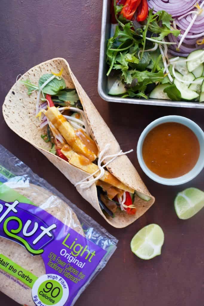 Crispy Tofu Wraps with Spicy Peanut Sauce: These are one of my favorite healthy vegetarian meals. Crispy tofu that's caramelized with a little maple syrup and loaded up with crunchy veggies and an easy spicy peanut sauce! YUM! | macheesmo.com