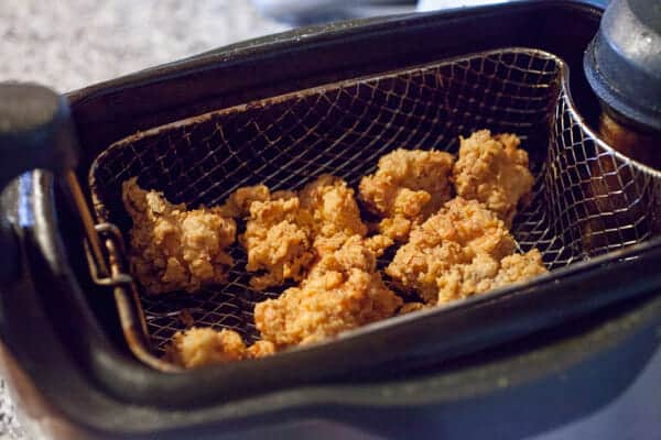 Frying the chicken wings.