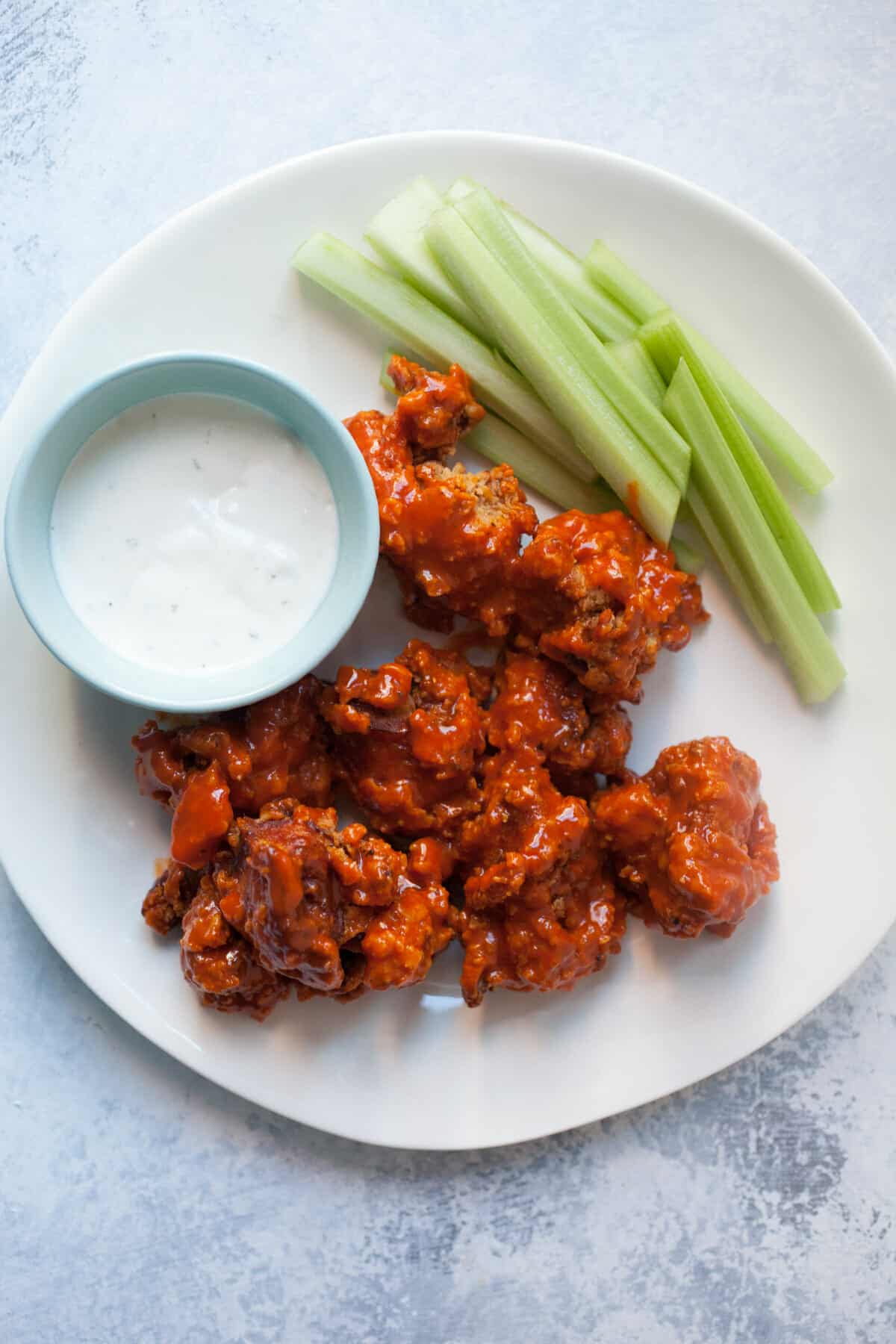 Real boneless chicken wings on a plate.