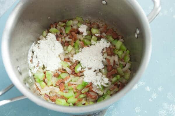 Adding flour to make a roux for salmon chowder.