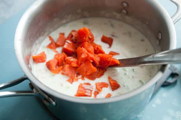 Adding the salmon at the very end of the chowder simmering.