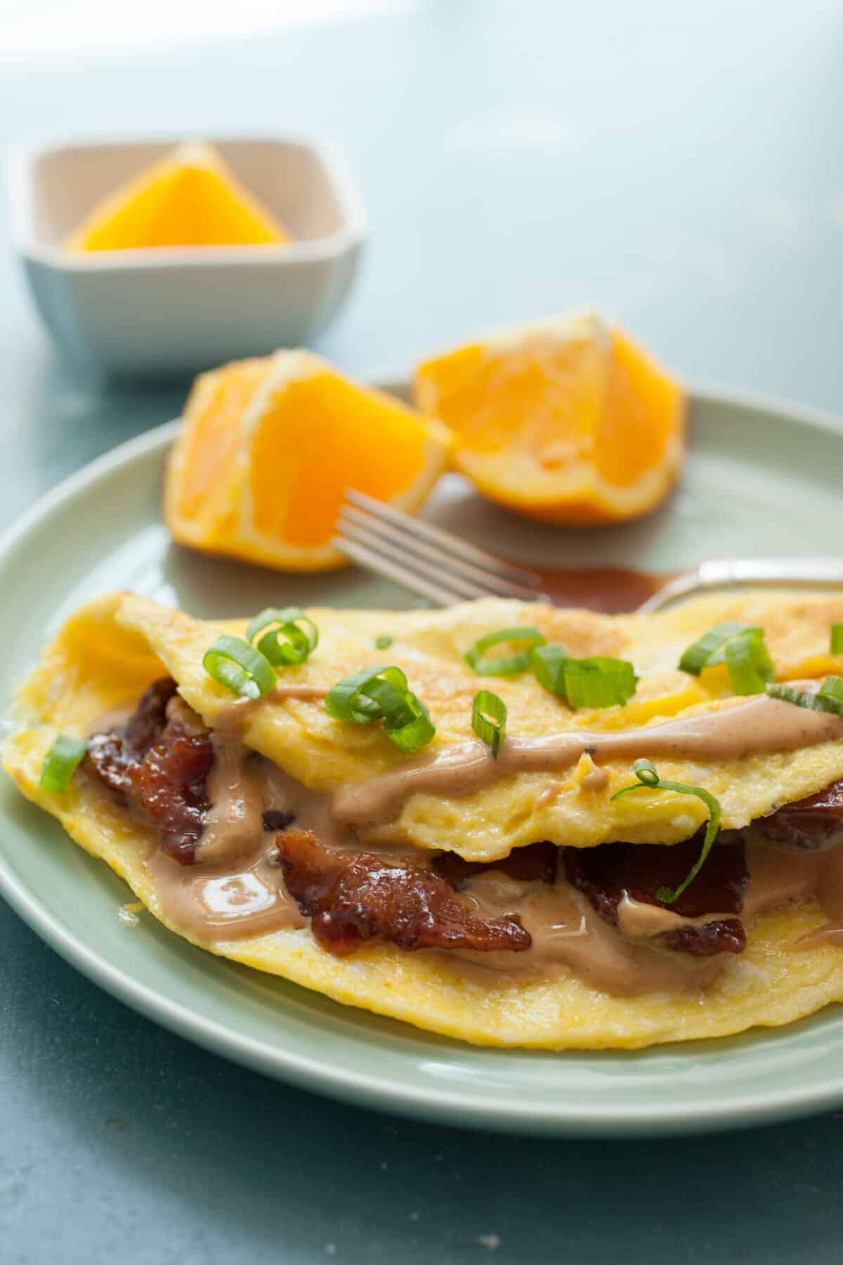 Peanut Butter Omelet with Candied Bacon: This might sound crazy, but with a few tips and tricks this omelet is ridiculously delicious. The key is some perfectly candied bacon! You gotta try this! | macheesmo.com
