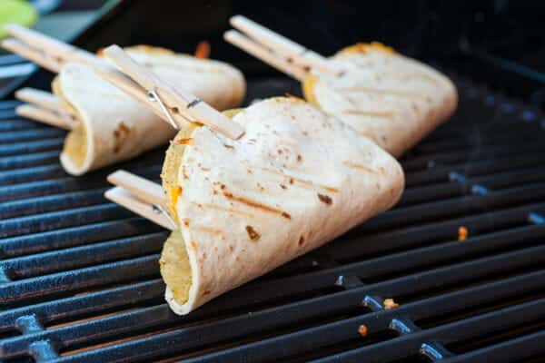 Flipping the grilled quesadilla taco shells.