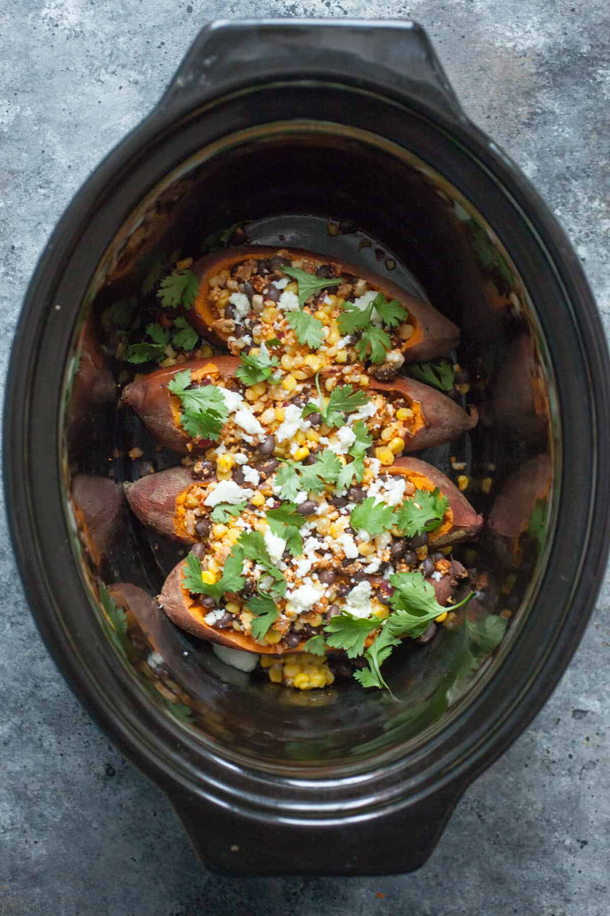 Stuffed Tex Mex Slow Cooker Sweet Potatoes: These sweet potatoes are the perfect mix of spicy, sweet, and savory and you can practically set them and forget them! A great vegetarian friendly meal! | macheesmo.com