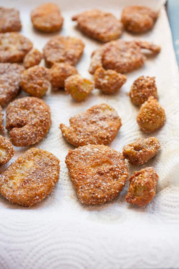 Fried green tomatoes on a sheet pan.