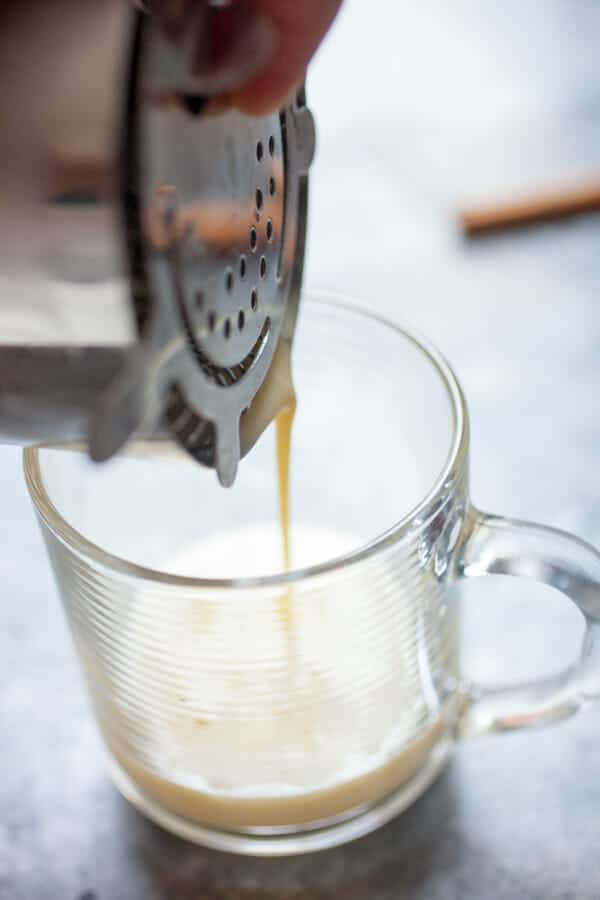 Straining the rum flip cocktail