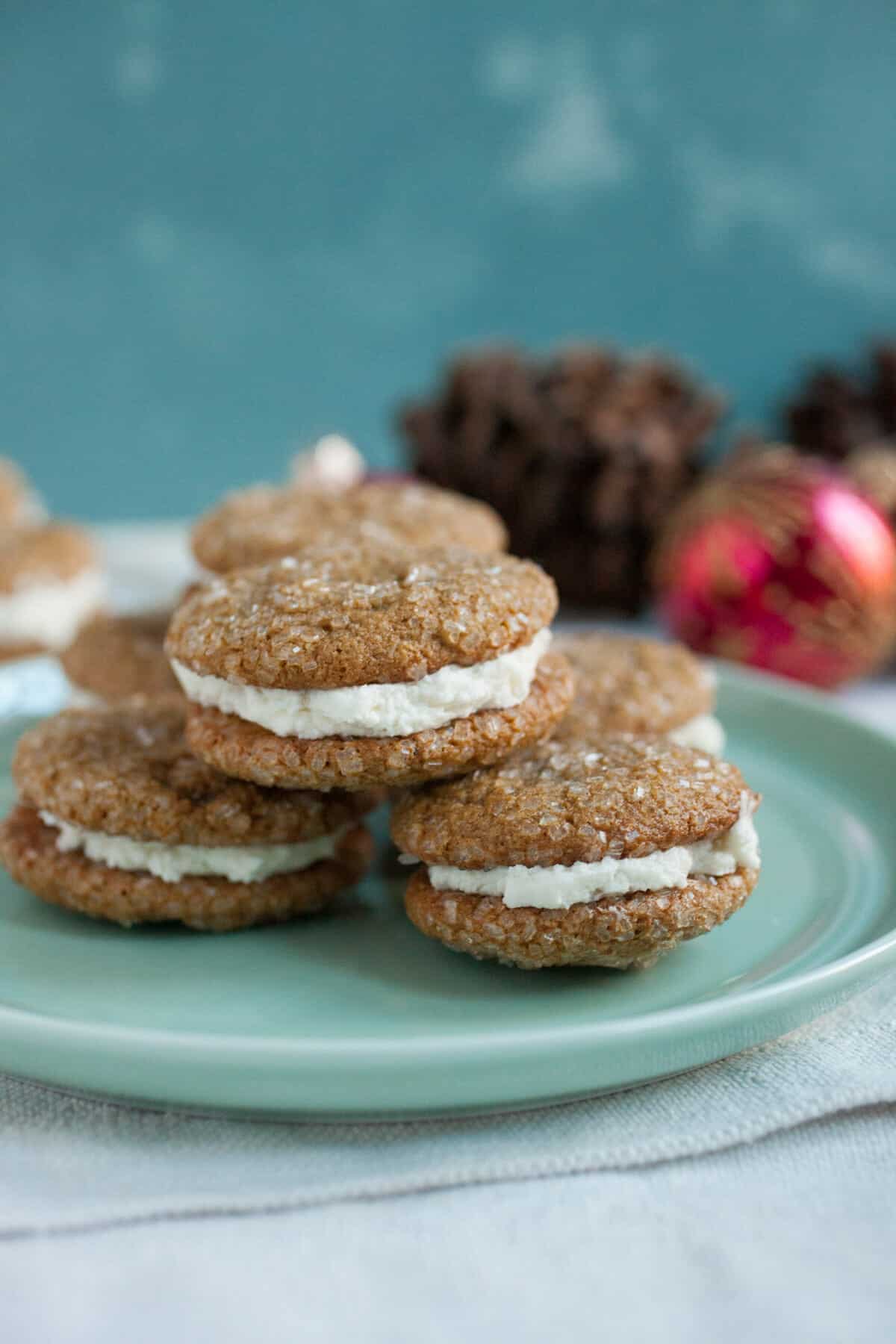 Gingerbread Sandwich Cookies: Soft gingerbread cookies coated in sparkling sugar and sandwiched around a simple buttercream filling. Your new favorite holiday cookie! | macheesmo.com