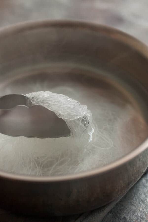 Boiling glass noodles in water.