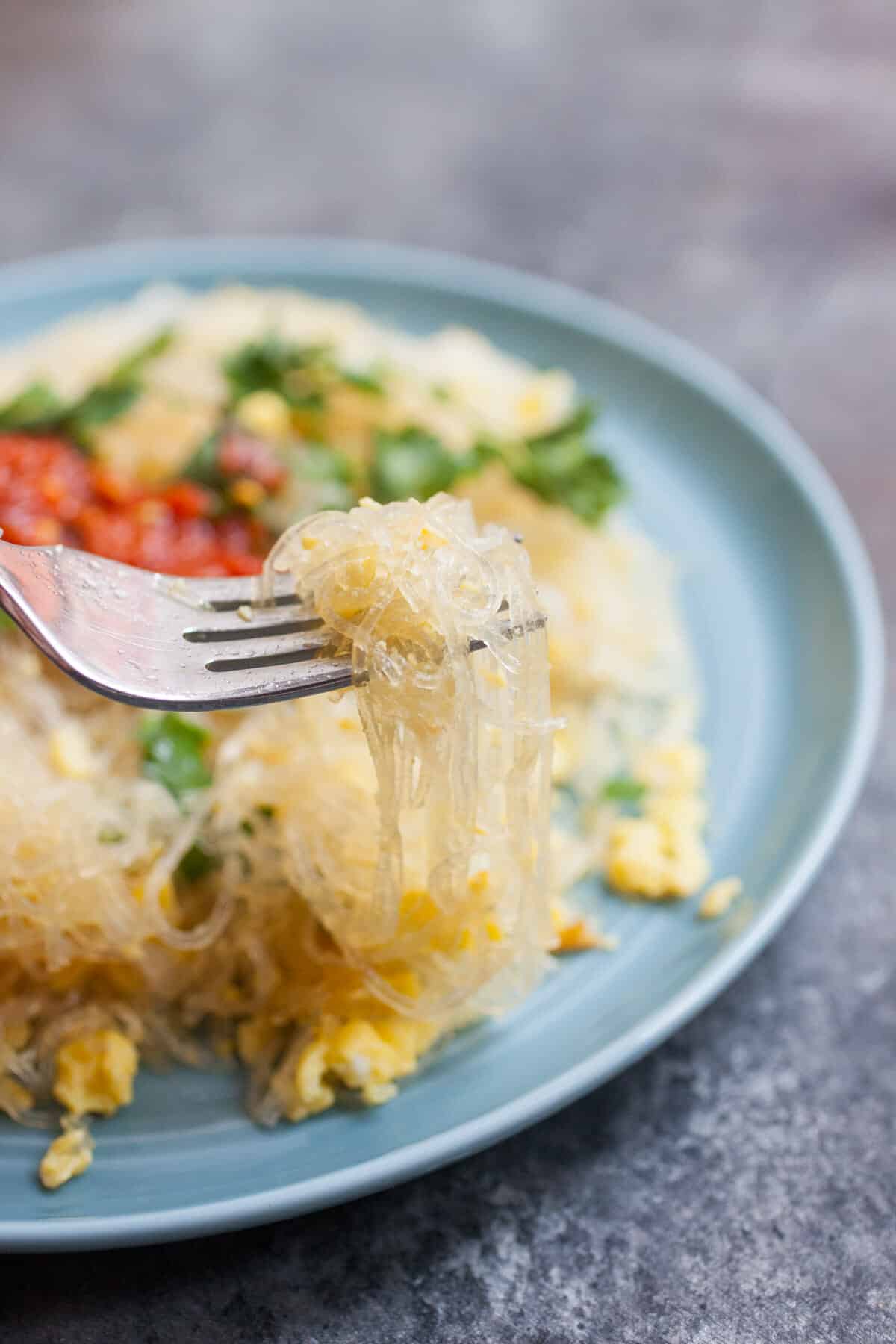 Noodles stir-fried with eggs on a fork.