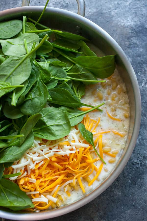 Wilting spinach in the skillet.