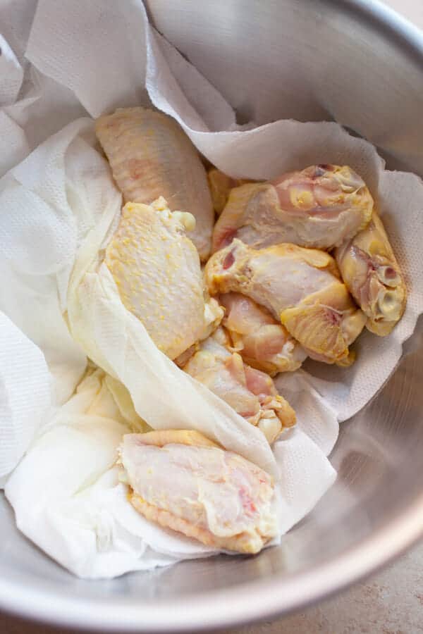 Removing pickle chicken wings from bag and drying them.