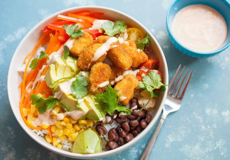 Buffalo Bites Bowls: These simple-to-make bowls are topped with Buffalo Fish Bites, loads of Tex-Mex veggies, and a simple spicy ranch sauce. Hard to beat! | macheesmo.com