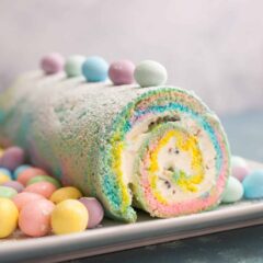 Easter Swiss Roll: A simple and colorful swiss roll filled with crushed candies and a cream cheese frosting. Perfect for Easter! | crunchtimekitchen.com #swiss #roll #easter