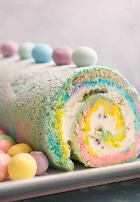 Easter Swiss Roll: A simple and colorful swiss roll filled with crushed candies and a cream cheese frosting. Perfect for Easter! | crunchtimekitchen.com #swiss #roll #easter