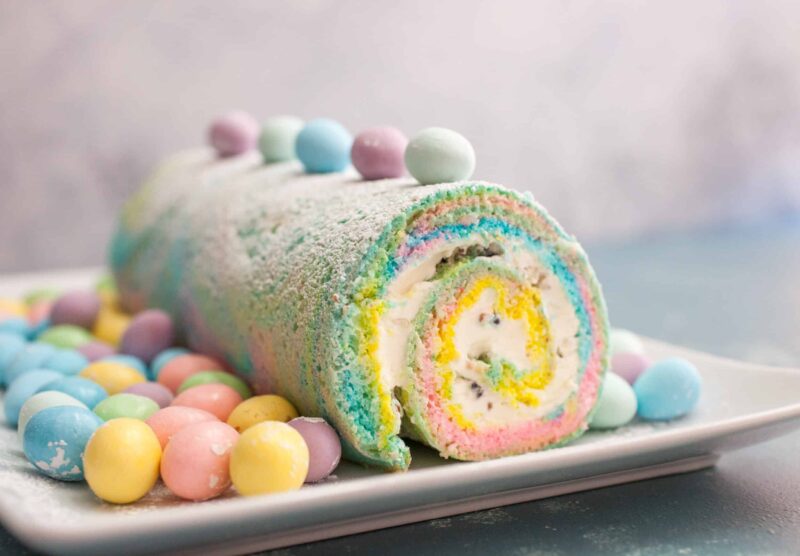 Easter Swiss Roll: A simple and colorful swiss roll filled with crushed candies and a cream cheese frosting. Perfect for Easter! | crunchtimekitchen.com #swiss #roll #easter
