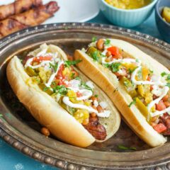 Sonoran Hot Dogs: Bacon wrapped grilled hot dogs topped with ALL the toppings you could ever want. These are the perfect jazzed-up hot dog for a backyard party! Inspired by the popular Tucson version. | macheesmo.com