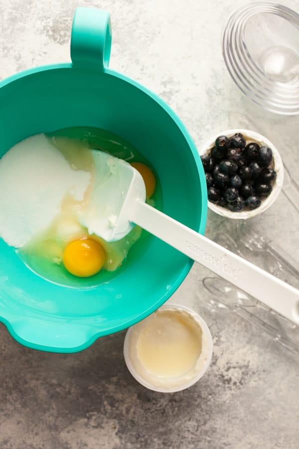 Mixing batter for yogurt cake in a bowl.