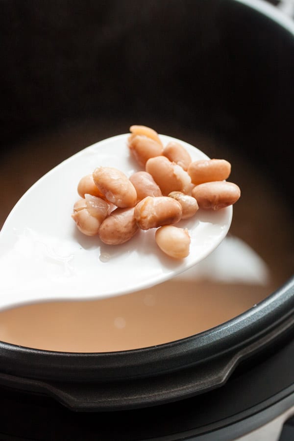 Pinto beans cooked and tender in a pressure cooker.