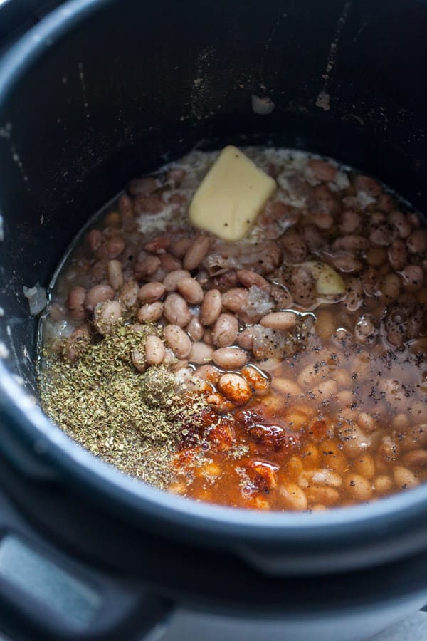 Adding butter and spices to the pinto bean dip.
