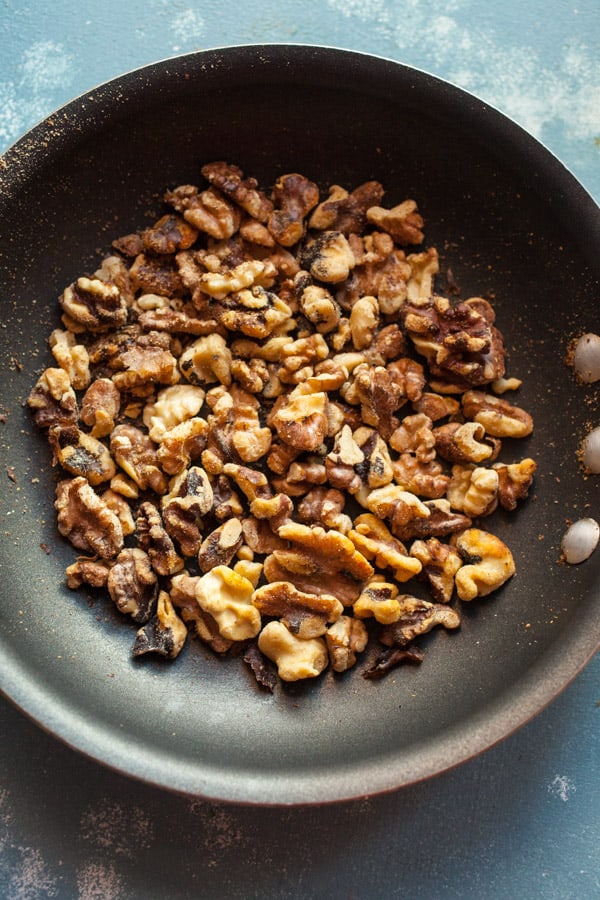 Toasted pecans in a skillet.