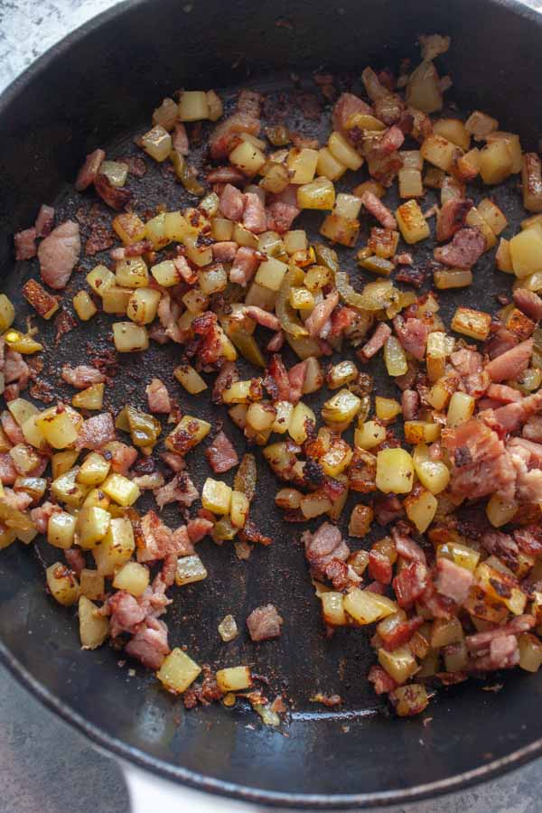 Potatoes and ham mix for breakfast tacos.