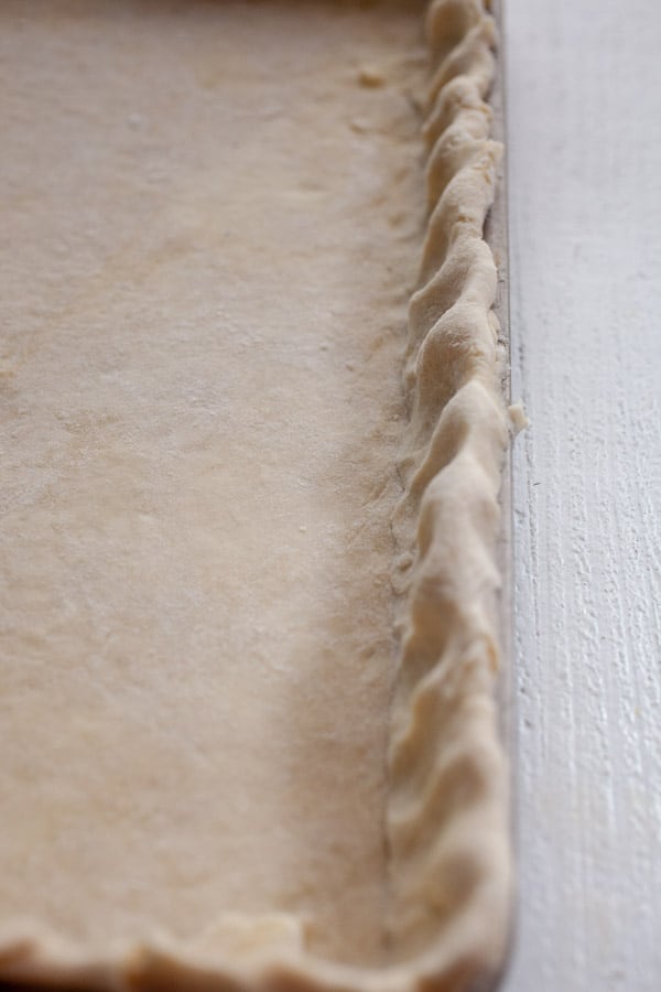 Quiche dough shaped in the sheet pan.