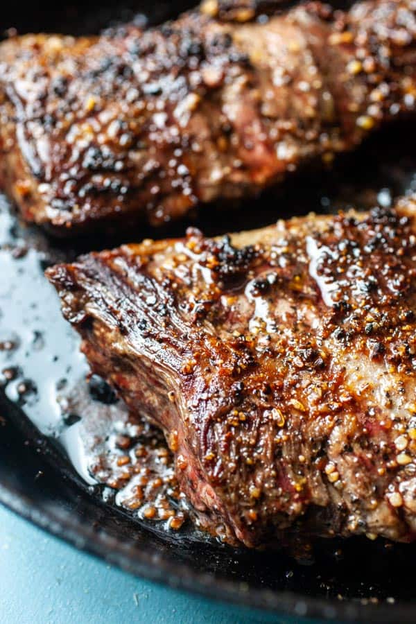 Seared skirt steak in a skillet.