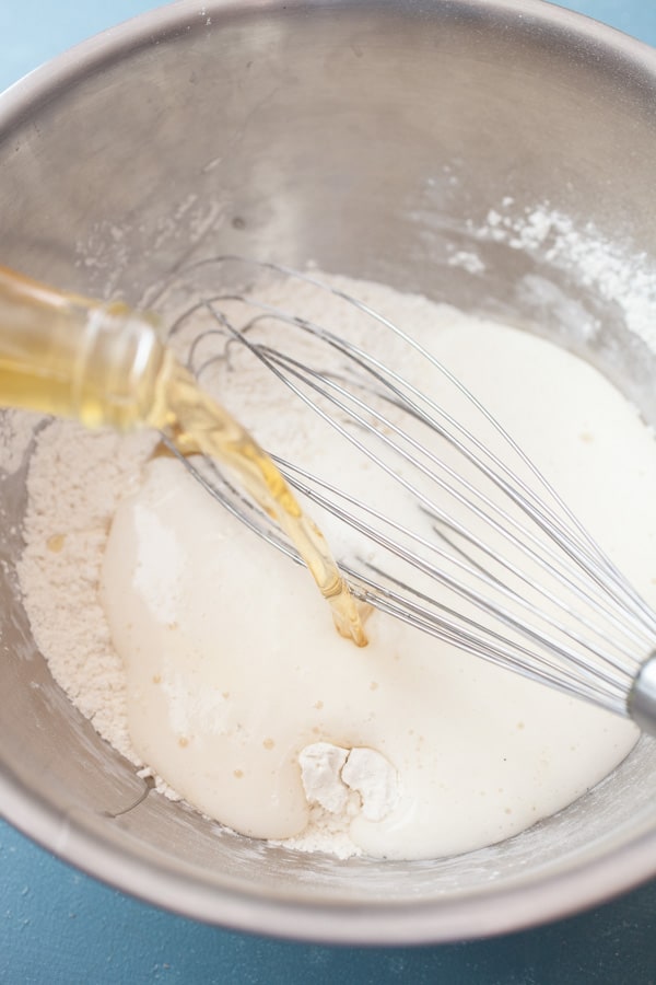 Adding lager beer to beer batter.