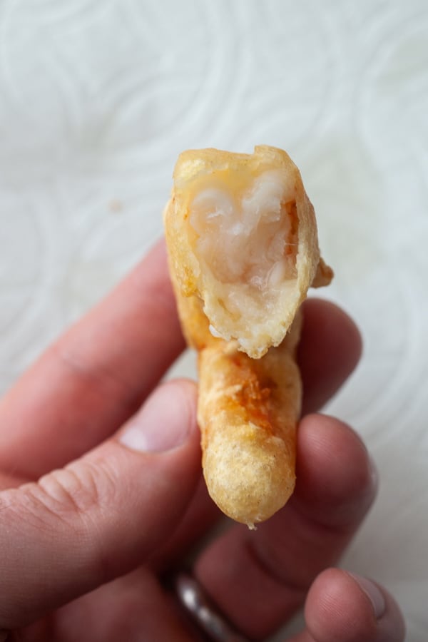 Tester bite from finished beer battered shrimp.