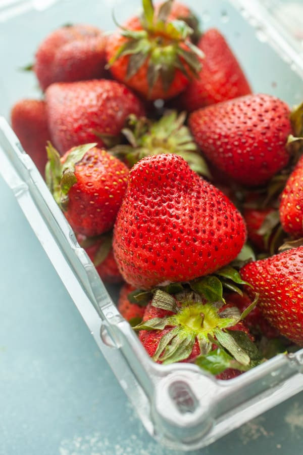 Fresh strawberries in a container for frozen yogurt.