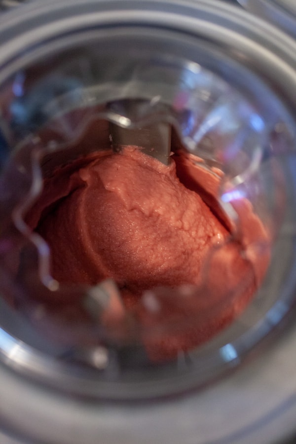 Making strawberry frozen yogurt in an ice cream churner.