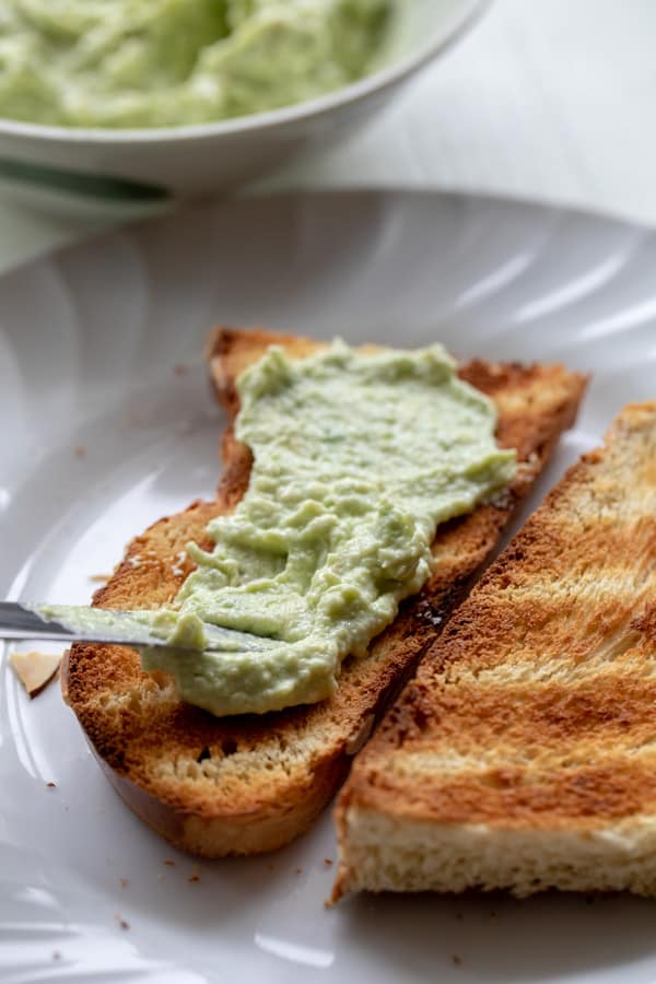 Spreading Avocado Butter Spread on toast