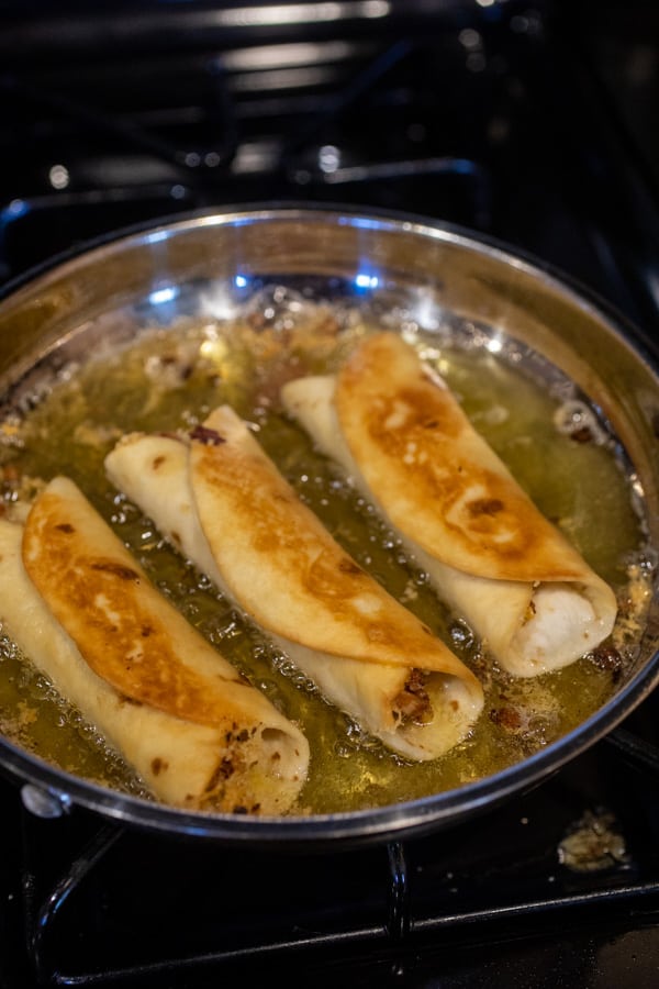 Frying the Chicken flautas in oil