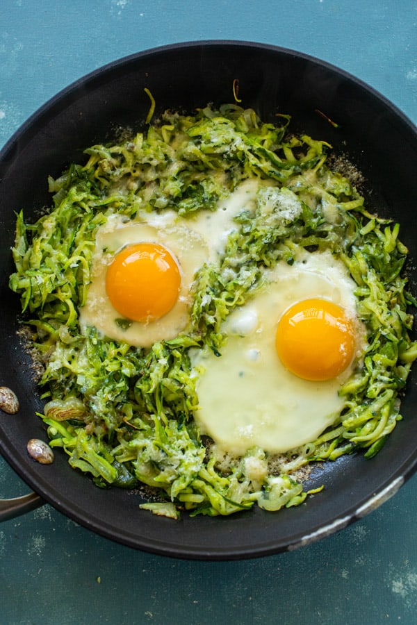 Eggs added to zucchini breakfast skillet.