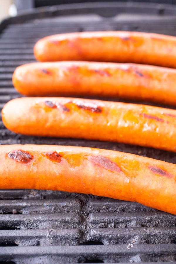 grilling sausages on grill.