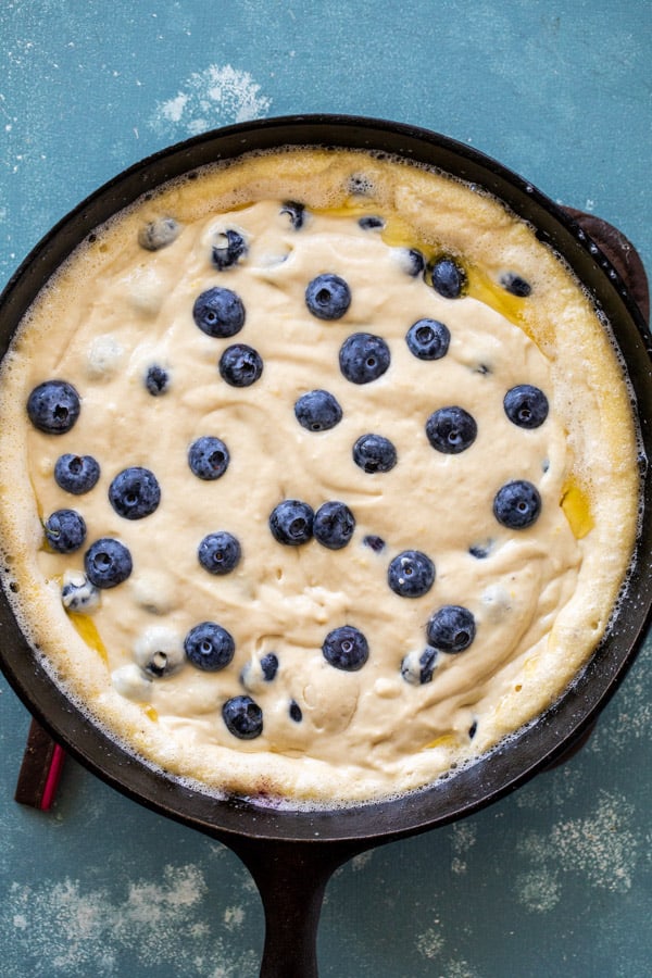 Batter and blueberries in the cast iron skillet.
