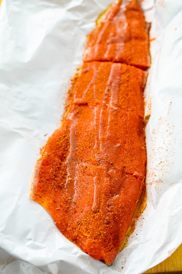 Prepping the Salmon with blackening seasoning.