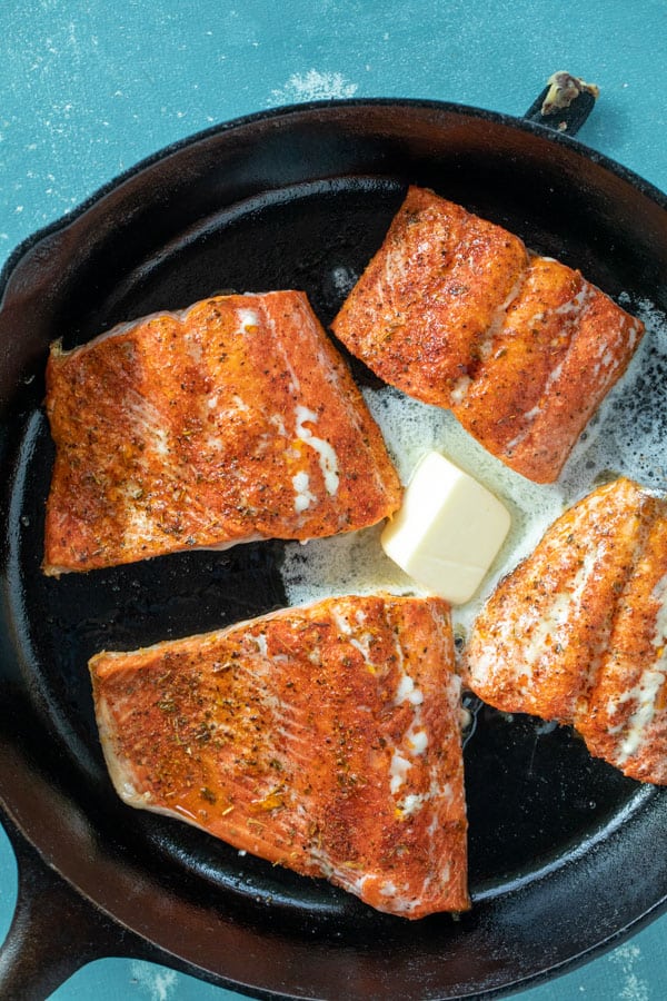 Butter added to blackened salmon