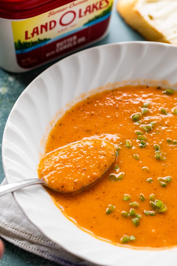 Tomato Soup made with fresh seasonal tomatoes, herbs, and garlic. Blended and thickened with a light roux to make for a wonderful fall Tomato Soup. Freezes well and ready in under an hour! Macheesmo.com #tomato #soup